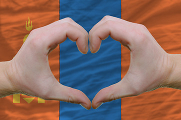 Image showing Heart and love gesture showed by hands over flag of mongolia bac