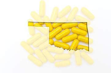 Image showing Outline map of oklahoma with transparent pills in the background