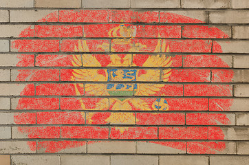 Image showing flag of montenegro on grunge brick wall painted with chalk  