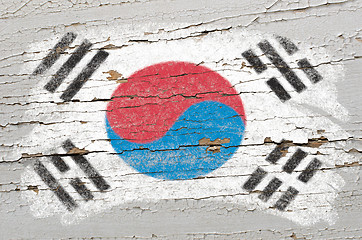 Image showing flag of South Korea on grunge wooden texture painted with chalk 