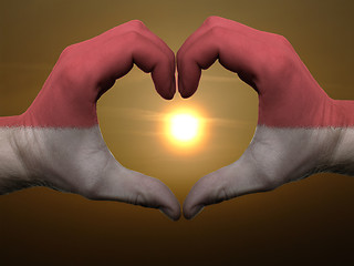 Image showing Heart and love gesture by hands colored in indonesia flag during