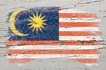 Image showing flag of Malaysia on grunge wooden texture painted with chalk  