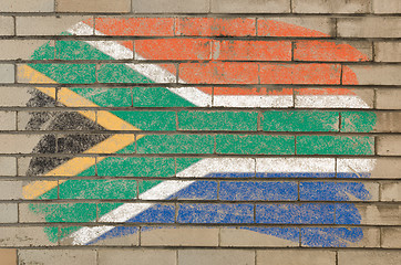 Image showing flag of South Africa on grunge brick wall painted with chalk  