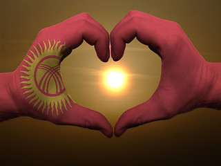 Image showing Heart and love gesture by hands colored in kyrghyzstan flag duri