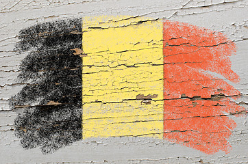Image showing flag of Belgium on grunge wooden texture painted with chalk  
