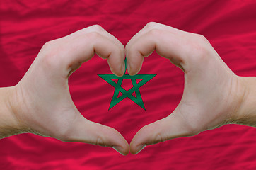 Image showing Heart and love gesture showed by hands over flag of morocco back