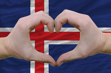Image showing Heart and love gesture showed by hands over flag of iceland back