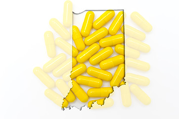 Image showing Outline map of Indiana with transparent pills in the background