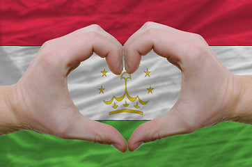 Image showing Heart and love gesture showed by hands over flag of tajikistan b