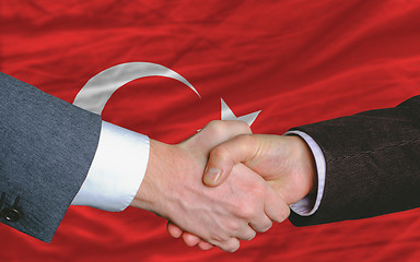 Image showing businessmen handshake after good deal in front of turkey flag