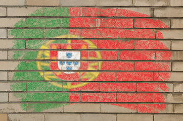 Image showing flag of Portugal on grunge brick wall painted with chalk  