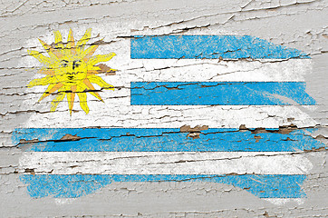 Image showing flag of uruguay on grunge wooden texture painted with chalk  