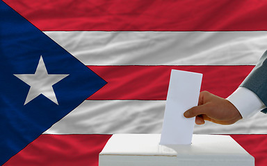 Image showing man voting on elections in puertorico in front of flag