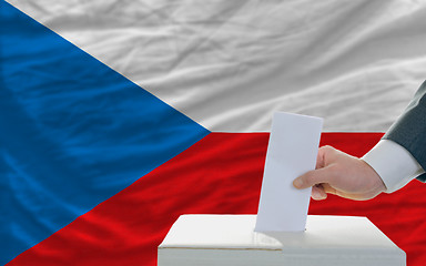 Image showing man voting on elections in czech in front of flag