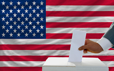 Image showing man voting on elections in america in front of flag