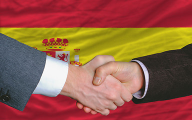 Image showing businessmen handshake after good deal in front of spain flag