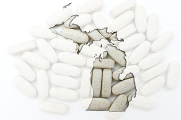 Image showing Outline map of michigan with transparent pills in the background