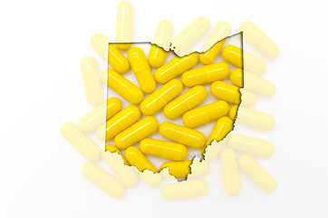 Image showing Outline map of ohio with transparent pills in the background