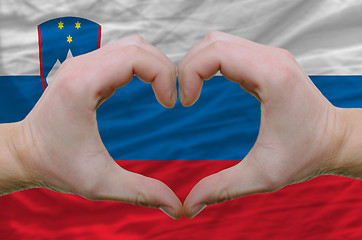 Image showing Heart and love gesture showed by hands over flag of slovenia bac