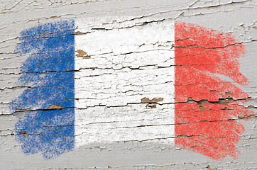 Image showing flag of France on grunge wooden texture painted with chalk  