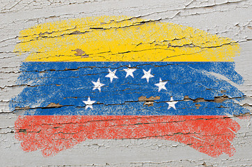 Image showing flag of venezuela on grunge wooden texture painted with chalk  