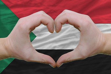 Image showing Heart and love gesture showed by hands over flag of sudan backgr