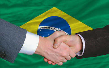 Image showing businessmen handshake after good deal in front of brazil flag