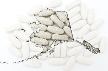 Image showing Outline Alaska map of with transparent pills in the background