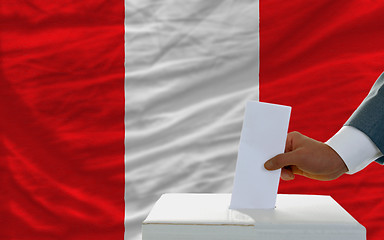 Image showing man voting on elections in peru in front of flag