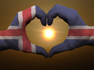 Image showing Heart and love gesture by hands colored in iceland flag during b