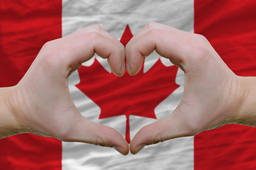 Image showing Heart and love gesture showed by hands over flag of canada backg