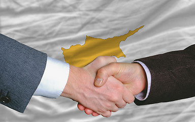 Image showing businessmen handshake after good deal in front of cyprus flag