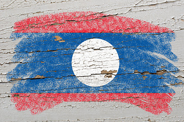 Image showing flag of laos on grunge wooden texture painted with chalk  