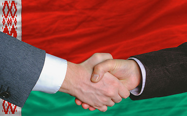 Image showing businessmen handshakeafter good deal in front of belarus flag