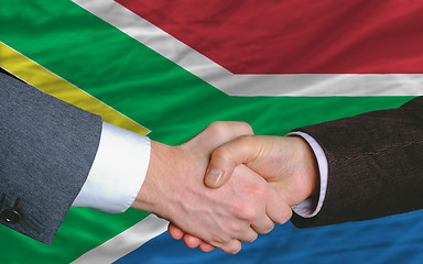 Image showing businessmen handshake after good deal in front of south africa f