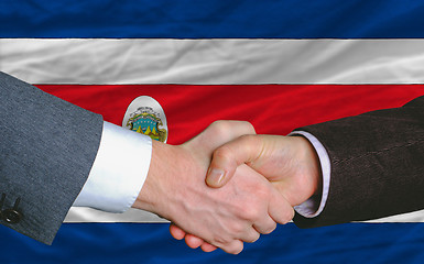 Image showing businessmen handshakeafter good deal in front of costarica flag