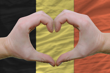 Image showing Heart and love gesture showed by hands over flag of belgium back