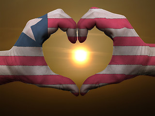 Image showing Heart and love gesture by hands colored in liberia flag during b