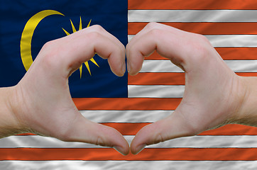 Image showing Heart and love gesture showed by hands over flag of malaysia bac