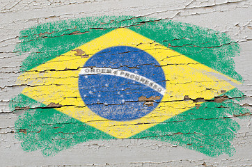 Image showing flag of Brazil on grunge wooden texture painted with chalk  