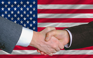 Image showing businessmen handshake after good deal in front of america flag