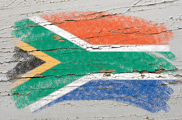 Image showing flag of South Africa on grunge wooden texture painted with chalk