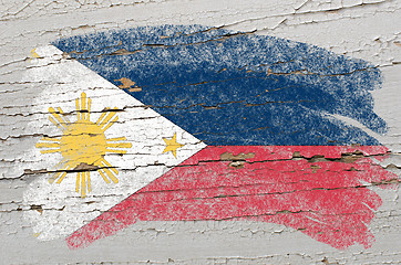 Image showing flag of phillipines on grunge wooden texture painted with chalk 