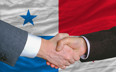 Image showing businessmen handshake after good deal in front of panama flag