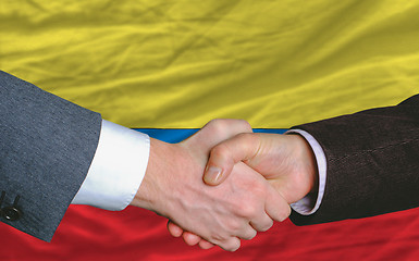 Image showing businessmen handshakeafter good deal in front of columbia flag