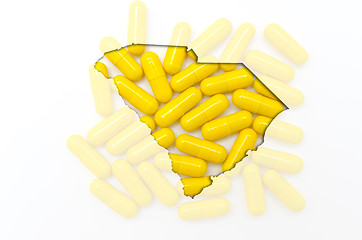 Image showing Outline map of south carolina with transparent pills in the back