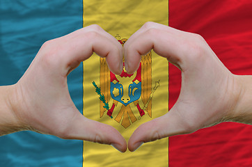 Image showing Heart and love gesture showed by hands over flag of moldova back