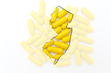 Image showing Outline map of new jersey with transparent pills in the backgrou