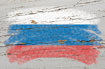 Image showing flag of Russia on grunge wooden texture painted with chalk  