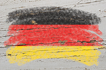 Image showing flag of Germany on grunge wooden texture painted with chalk  
